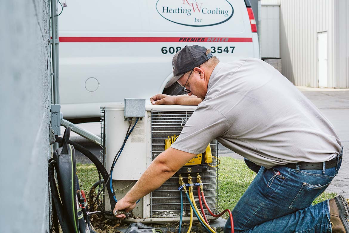 R&W Heating worker performing an HVAC Inspection