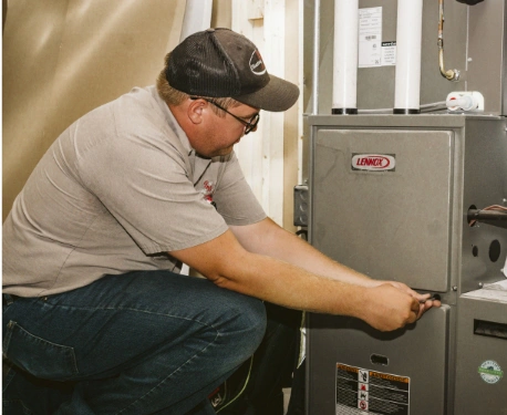 employee servicing a furnace