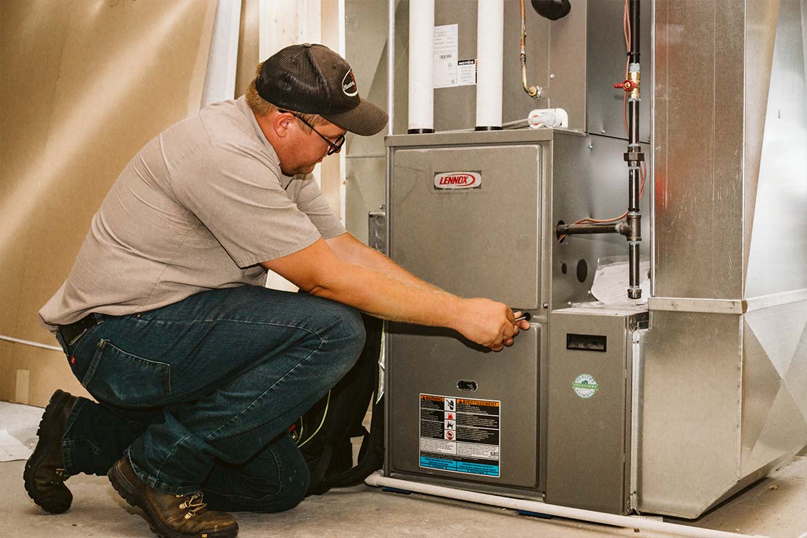 R&W Heating employee performing an HVAC installation