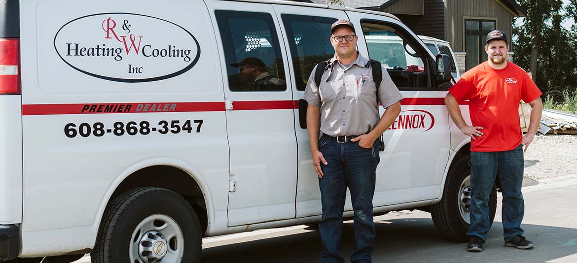 Some R&W Heating employees in front of a service van